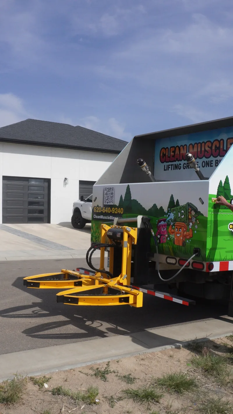 Technician pressure washing a residential driveway