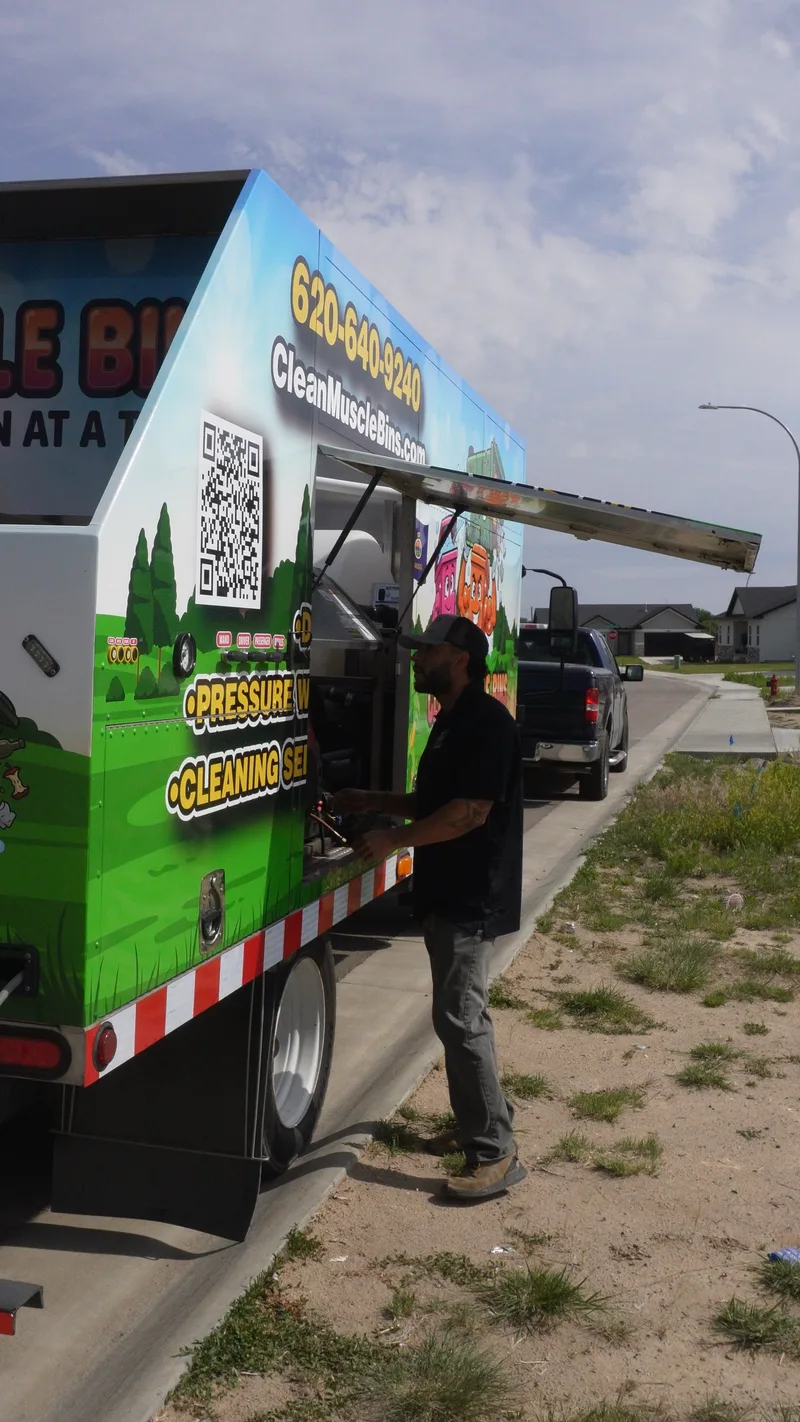 Clean Muscle Bins technician with service truck at a commercial property